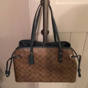 Coach Drawstring carryall in signature print.